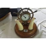 A late Victorian naval clock with ships wheel & a pair of tusk (much later movement(