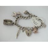 A silver charm bracelet with heart padlock