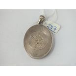 A large Victorian silver oval locket with floral motif
