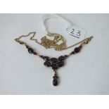 A gilt & garnet drop pendant necklace
