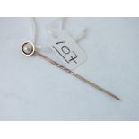 A pearl topped stick pin in 9ct