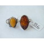 Two x silver & amber rings