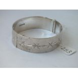 A wide silver engraved bangle