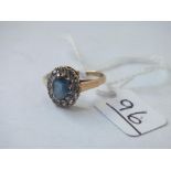 A blue stone ring with white stones around in 9ct - size N - 2.2gms