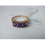 A four stone amethyst ring with diamond spacers set in 9ct - size P - 2.3gms