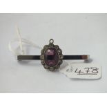 A antique purple stone & paste pendant - marked 585 on metal pin