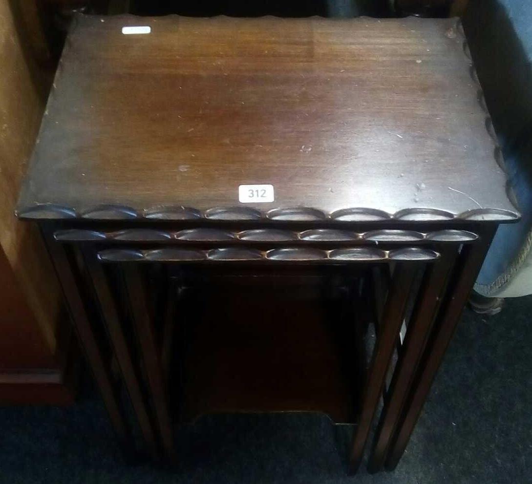 OLDER STYLE MAHOGANY NEST OF THREE TABLES WITH PIE CRUST EDGING