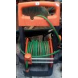 LONG GARDEN HOSE ON REEL & WHEELED STAND
