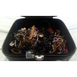 BLACK VANITY CASE WITH A LARGE QTY OF COSTUME JEWELLERY, CHAINS, NECKLACES ETC