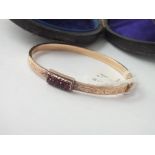 Boxed gold and garnet bangle - 9.2gms