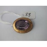 Attractive oval amethyst brooch in 12ct gold - 5.9gms