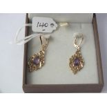 Boxed 9ct dangle earrings with purple stone