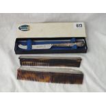 Two silver mounted combs and a boxed butter knife