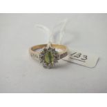 9ct ring with central pale green stone surrounded by white stones - size Q - 2.6gms