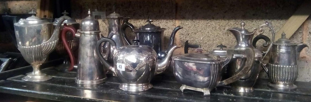 SHELF OF VARIOUS SHAPED PLATED COFFEE POTS, TEA POTS & WATER JUGS