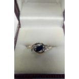 A SAPPHIRE & WHITE STONE RING SET IN 9ct