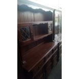 JAYCEE LARGE CARVED OAK DRESSER WITH LEADED GLASS DOORS, CUPBOARDS, DRAWERS ETC