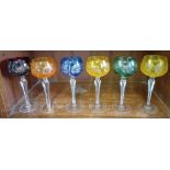A set of 6 coloured and cut glass wine glasses.