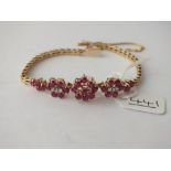 A RUBY & DIAMOND FANCY CLUSTER BRACELET IN 14CT GOLD - 12.1gms