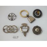 Six assorted brooches, child's rattle etc.