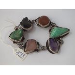 A silver stone set panel bracelet