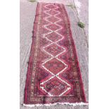 A red ground runner with 8 medallions - 9'9" x3'8"