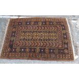 A belouch mustard/orange ground rug - 4' x 3'