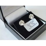 A pair of stud earrings with large white stones set in a claw mount in 9ct - boxed