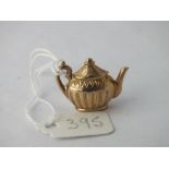 A charm in the form of a large tea pot in 9ct - 1.9gms