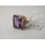 A large amethyst dress ring with diamond shoulders set in gold - size O - 9gms