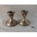 A pair of candle sticks with reeded rims - 3" high - London 1926