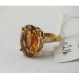 A very large oval orange stone ring (citrine?) in 9ct - size P - 6.3gms