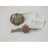 Two silver brooches - 1 military in form of a riffle & 1 Lyre shaped, marked music