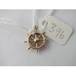 A ships wheel charm in 9ct - 1.6gms