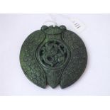 A large ornately carved greenstone dragon pendant - 7cm - 63gms