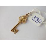 A charm in the form of a 21 Key in 9ct - 2.1gms