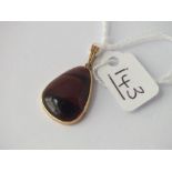 A tigers eye pendant marked 9ct
