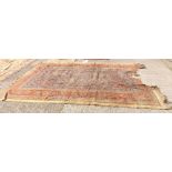 A antique blue ground carpet with red border (damaged) - 12' x 9'