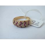 A ruby & diamond zig zag ring in 18ct gold - size U - 6.5gms