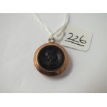 A gilt circular intaglio pendant