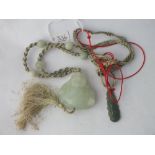 Two oriental green stone pendants incl. 1 of Buddha