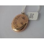 A Victorian oval back & front locket - 30 x025mm engraved with swallows & flowers - 4.9gms