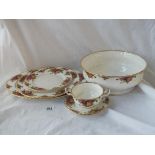 An oval meat plate, a cake stand (no metalwork), a large fruit bowl and a soup bowl and saucer