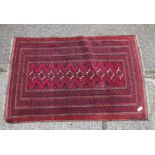 A red ground belouch rug with wide borders & 10 medallions - 5'9" x 3'