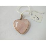 A silver rose quartz heart shaped pendant