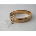 A FANCY BANGLE IN 9CT - 16gms