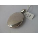 A Victorian oval silver locket - 42 x 34mm excl. bale