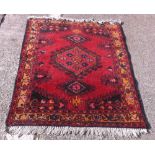 A small red ground rug with 3 madellions - 3'6 x 2'9"