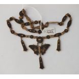 A shakudo necklace with butterfly motif