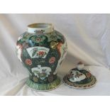 A large decorative Chinese famille verte jar and cover with flowering plant panels 16" high
